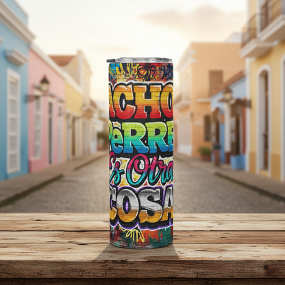 Colorful tumbler with text on a wooden surface in front of a colorful street scene.