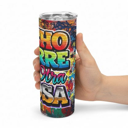 Colorful tumbler with text held by a hand on a white background
